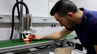 Juan Manuel Cáceres, places an iberian pork loin under the NIR scanner to perform a quality analysis